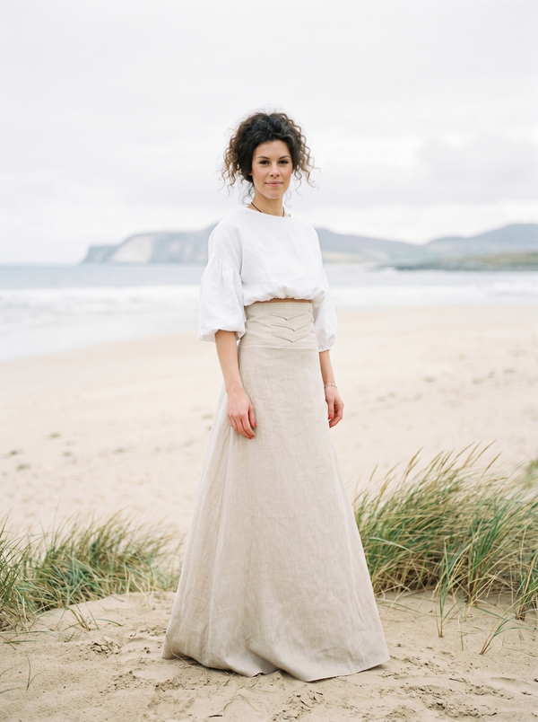 Natural linen maxi skirt with wide structured waistband on overcast Atlantic beach — Souls In Clothes
