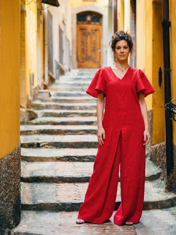 Red linen butterfly-sleeve jumpsuit on saffron-yellow village stairs — Souls In Clothes