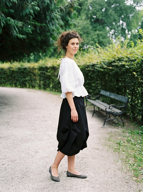 White linen puff-sleeve blouse tie-back ribbon detail in European park — Souls In Clothes